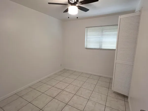 an empty room with a ceiling fan