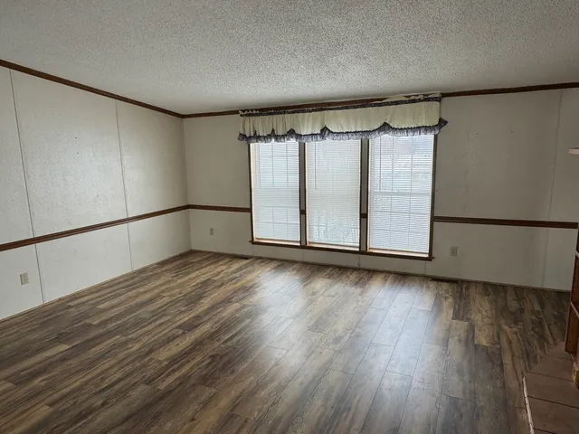 a view of a room with wooden floor