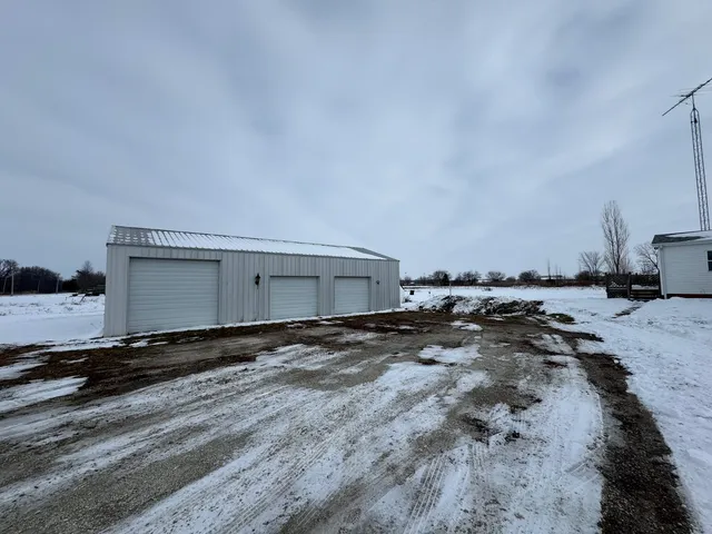 a view of a dirt road and a building