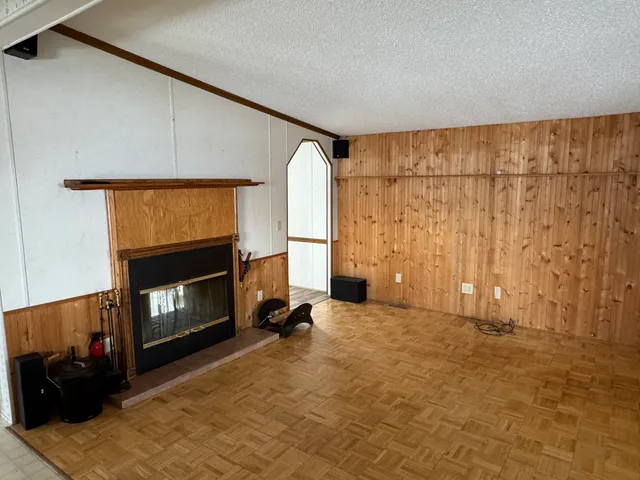 a view of a livingroom with a fireplace and a window