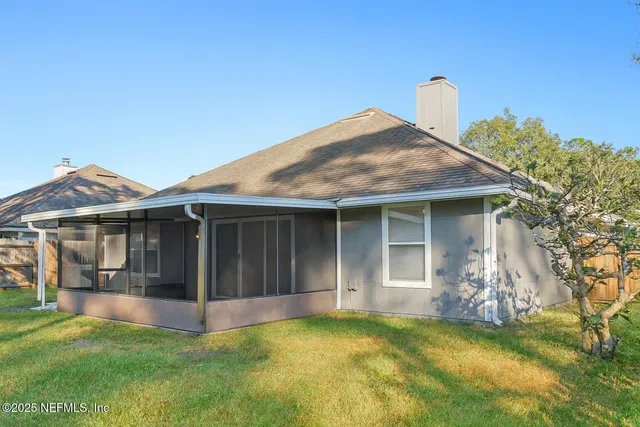 a view of a house with a yard and a garden