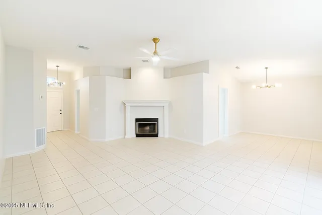 a view of an empty room with a fireplace