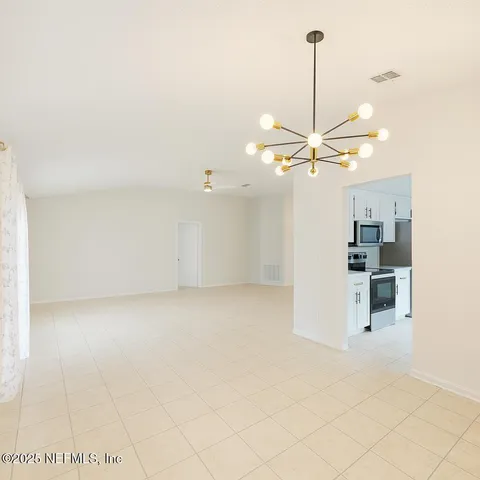 a view of a kitchen with a sink and a refrigerator