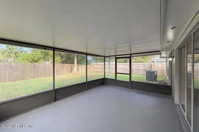 a view of an empty room with a large window