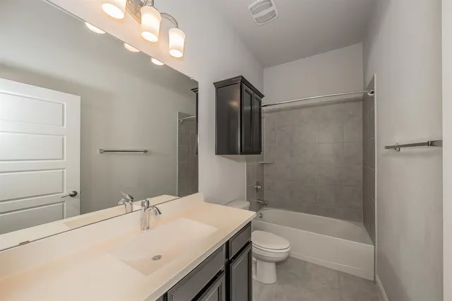 a bathroom with a sink a toilet and mirror