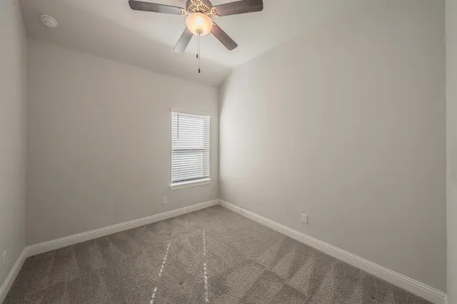 en empty room with a fan and a fan