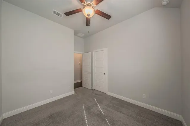 a view of an empty room and closet area