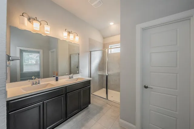 a bathroom with a glass shower door