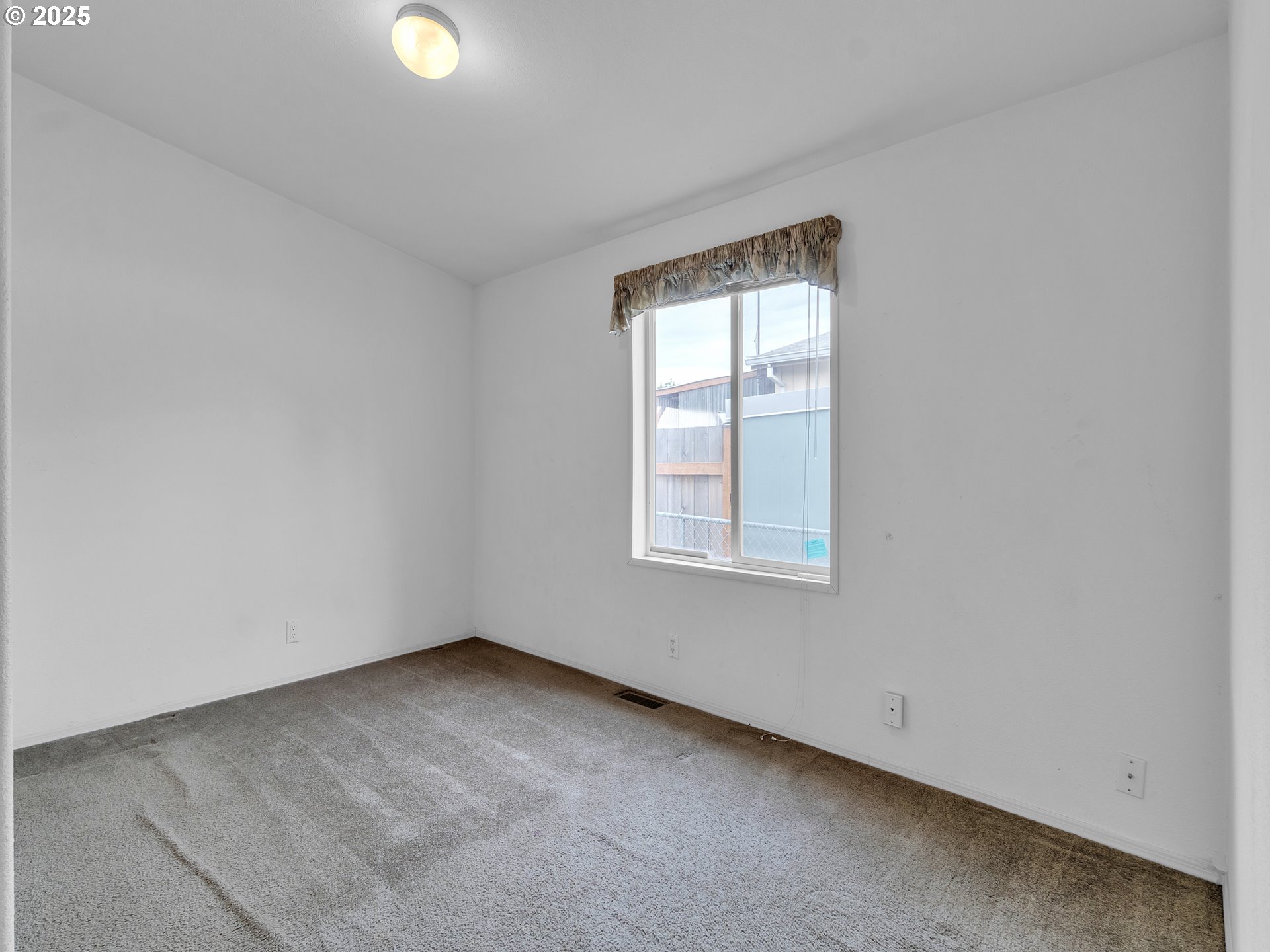 1005 Ferry Street, Unit 26 Dayton, OR 97114 - Photo 15 of 15 an empty room with a window