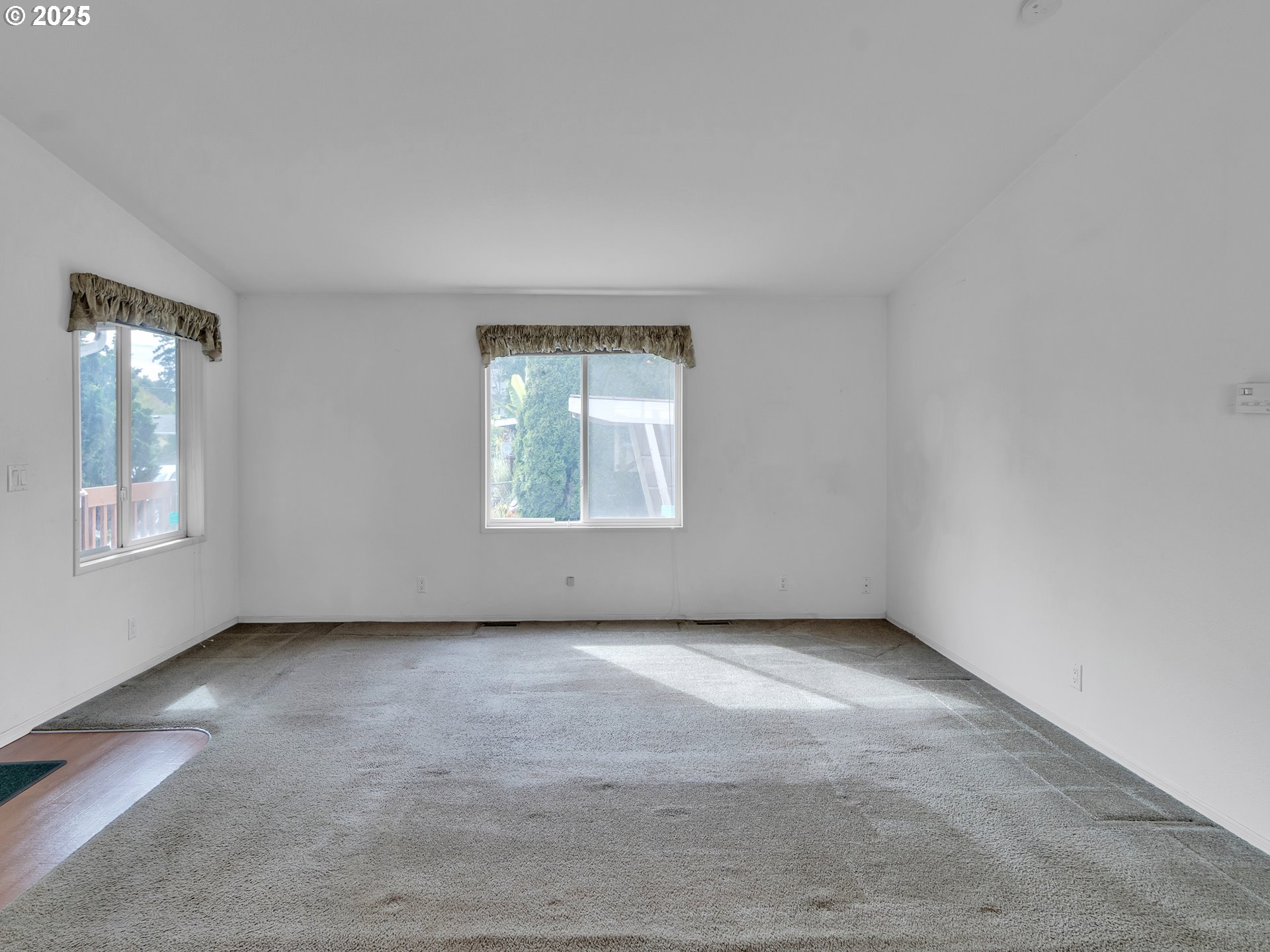 1005 Ferry Street, Unit 26 Dayton, OR 97114 - Photo 6 of 15 an empty room with windows