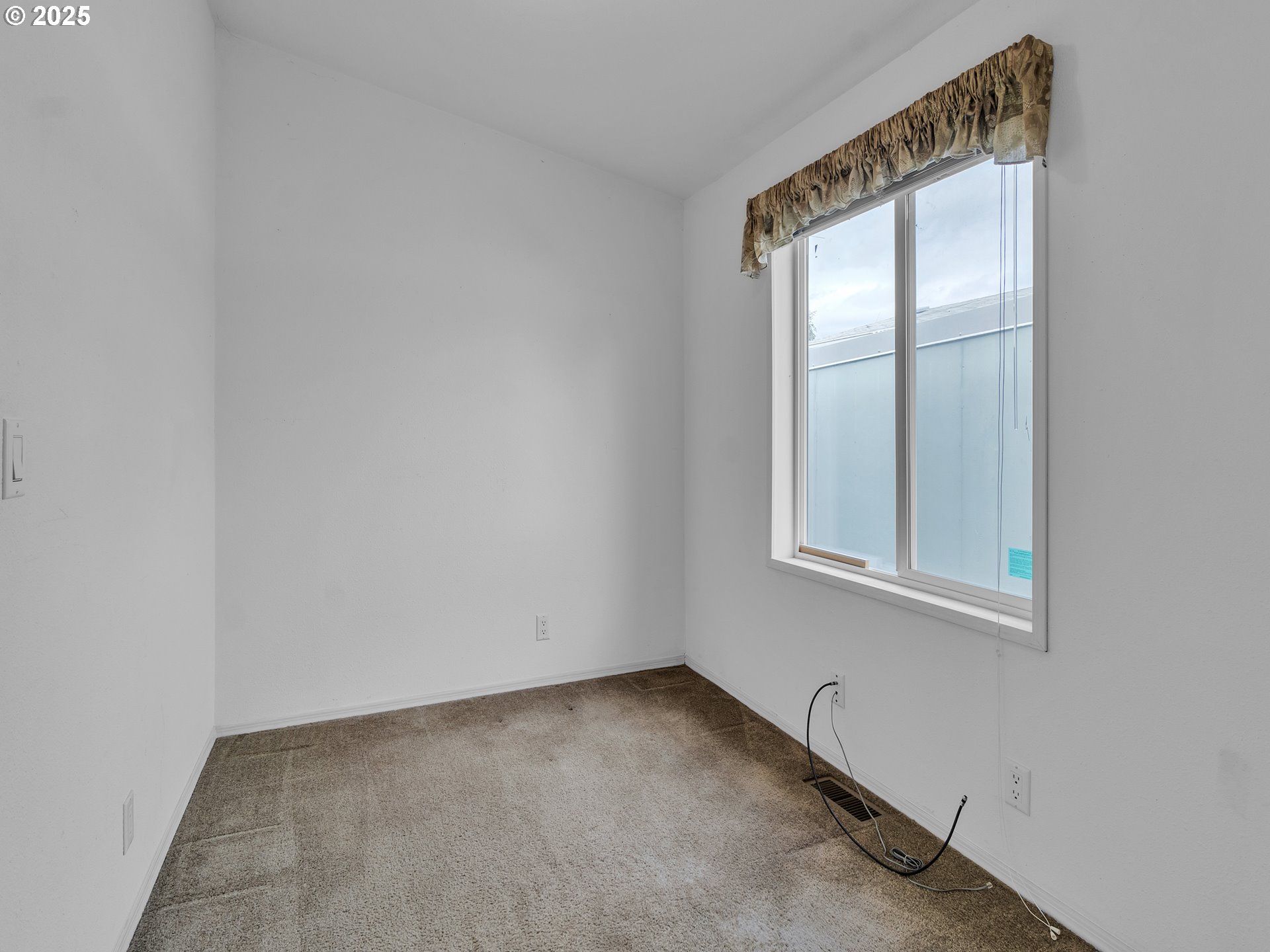 1005 Ferry Street, Unit 26 Dayton, OR 97114 - Photo 10 of 15 an empty room with windows