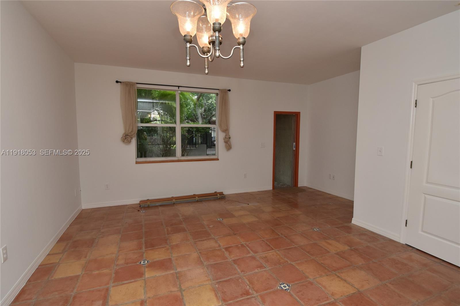 3051 Center Street, Unit 9 Miami, FL 33133 - Photo 5 of 11 a view of an empty room with a window
