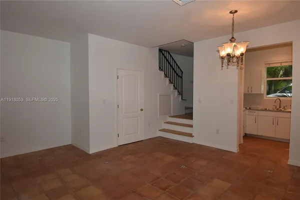 a view of a hallway with chandelier and entryway