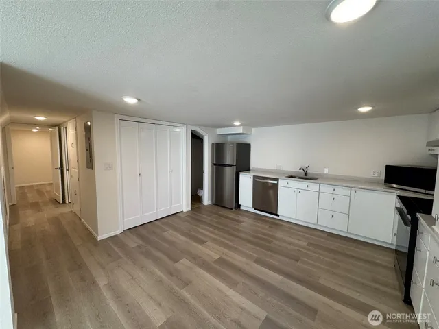 a view of a kitchen with wooden floor