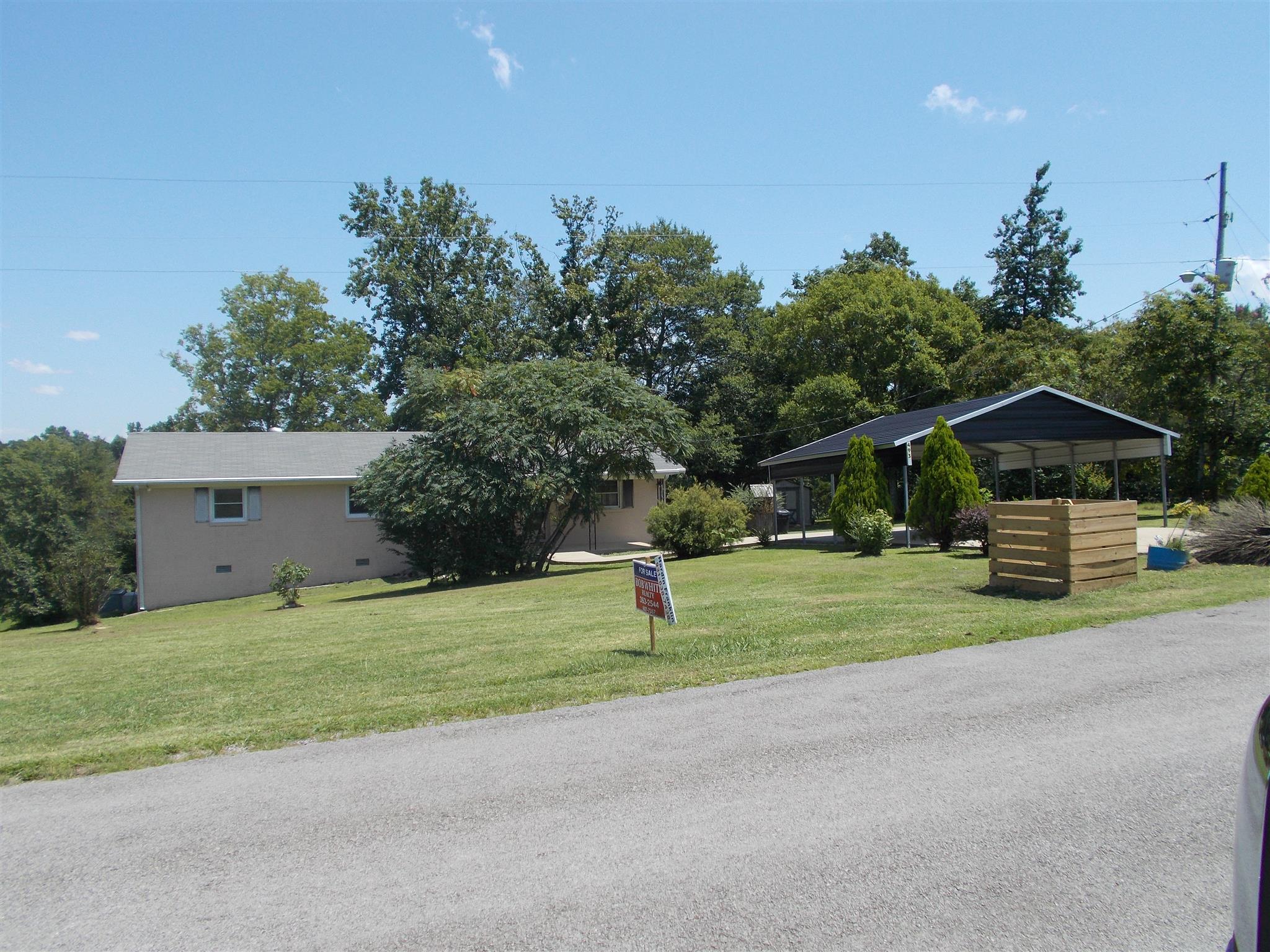 493 Nancy Green Ridge Road Prospect, TN 38477 - Photo 8 of 8 a house with green field in front of it