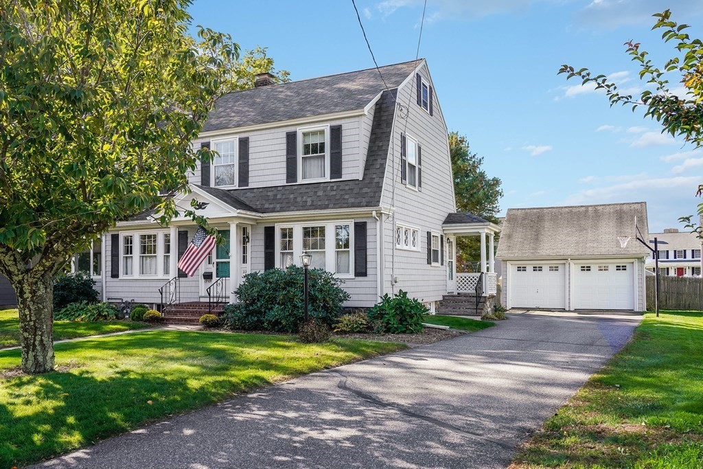 22 Elm Street Woburn, MA 01801 - Photo 1 of 31 a front view of a house with garden and trees