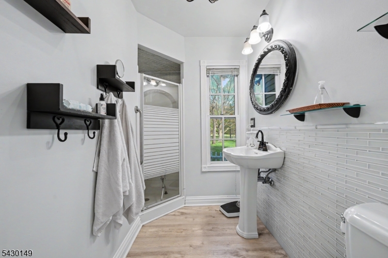 325 Matchaponix Road Old Bridge, NJ 08831 - Photo 11 of 21 a bathroom with a toilet sink and mirror