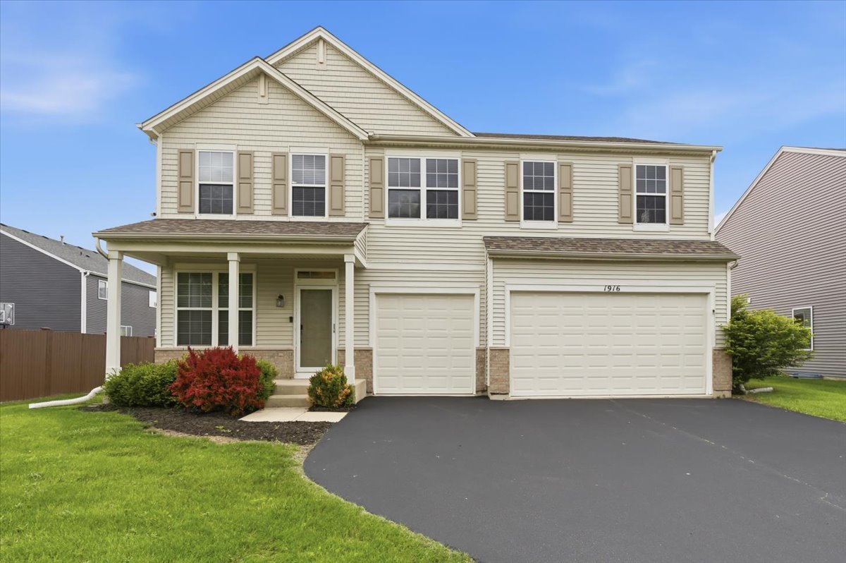 1916 Castle Ridge Drive Plainfield, IL 60586 - Photo 1 of 36 a front view of a house with a garden and garage