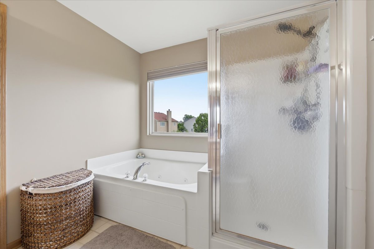 1916 Castle Ridge Drive Plainfield, IL 60586 - Photo 20 of 36 a bathroom with a tub and shower