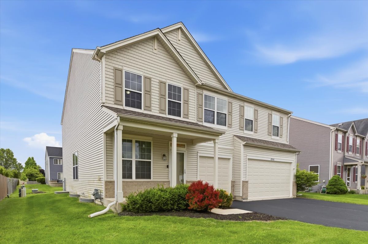 1916 Castle Ridge Drive Plainfield, IL 60586 - Photo 2 of 36 a front view of a house with a yard and garage