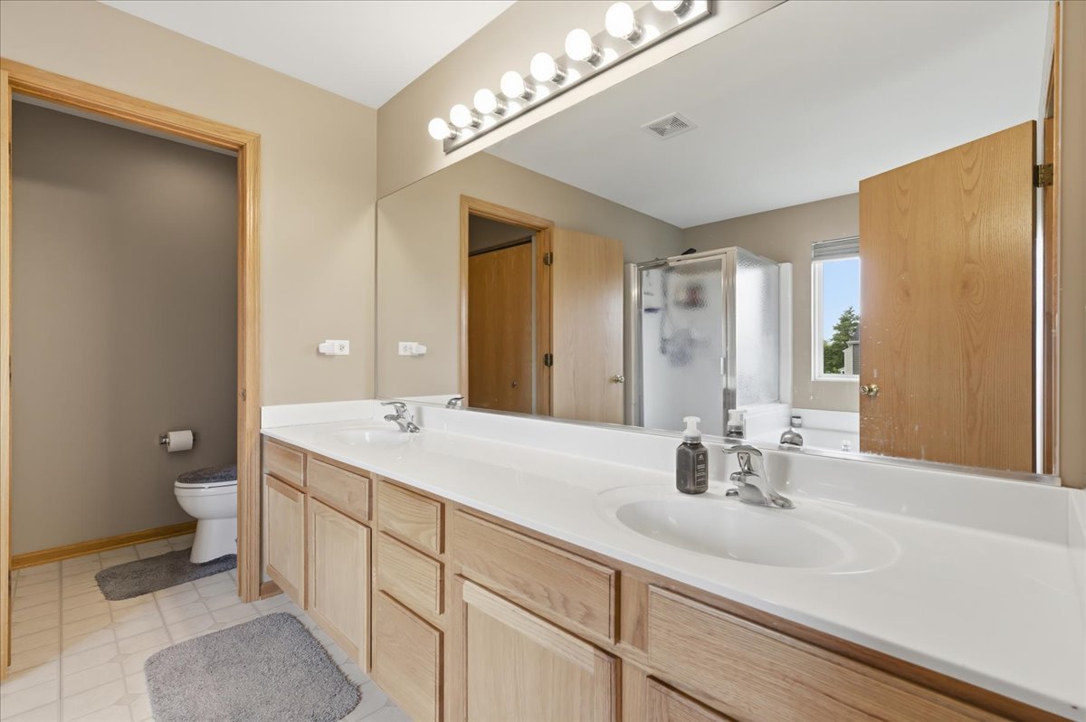 1916 Castle Ridge Drive Plainfield, IL 60586 - Photo 21 of 36 a bathroom with a sink double vanity and a mirror