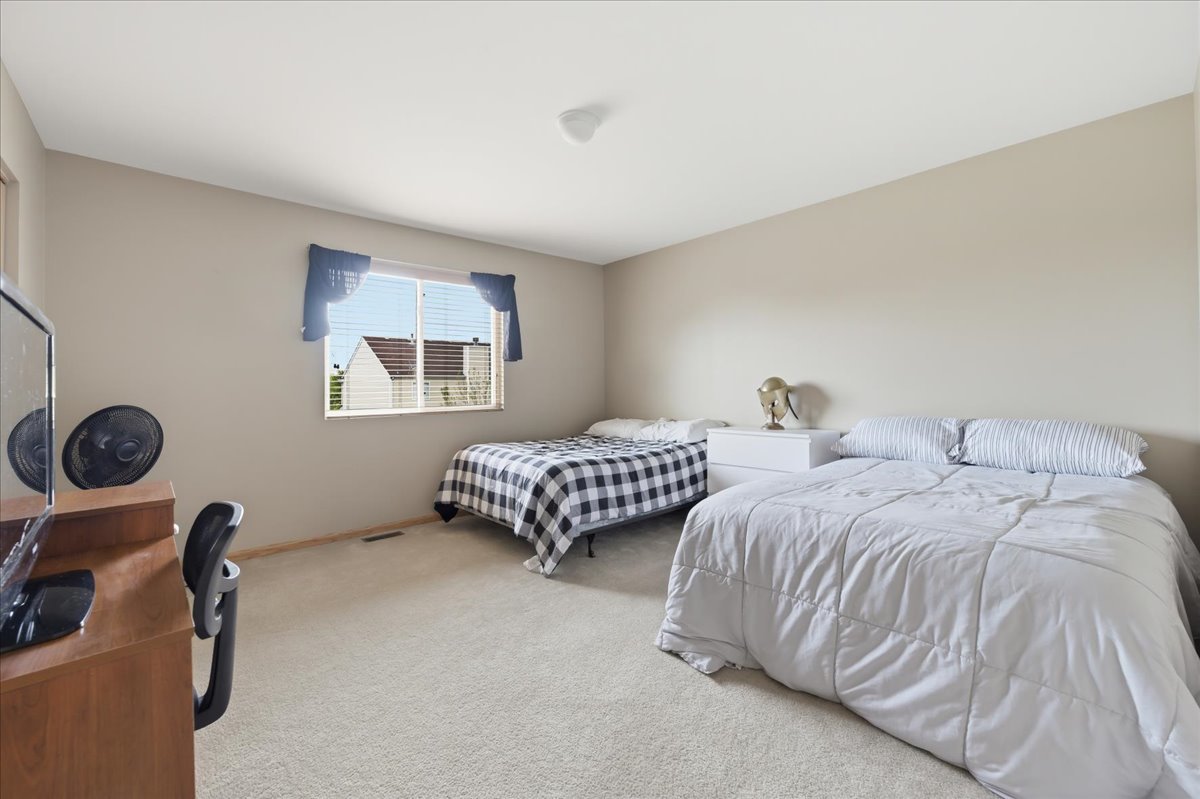 1916 Castle Ridge Drive Plainfield, IL 60586 - Photo 25 of 36 a bedroom with two beds and a dresser
