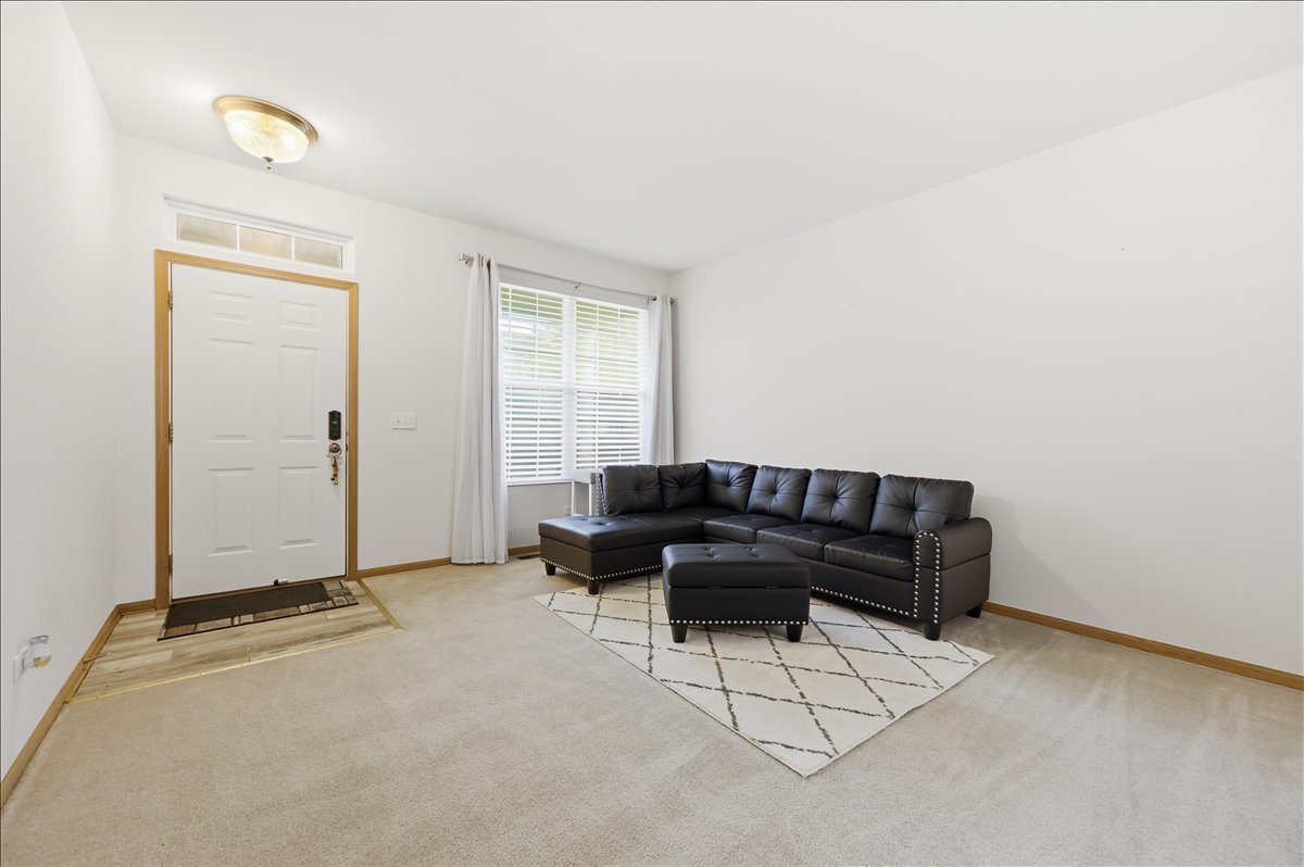 1916 Castle Ridge Drive Plainfield, IL 60586 - Photo 4 of 36 a living room with furniture a ceiling fan and a window