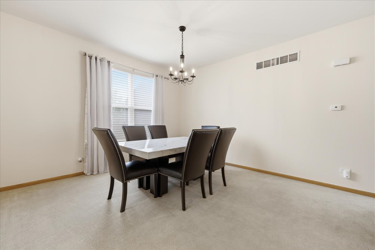 1916 Castle Ridge Drive Plainfield, IL 60586 - Photo 5 of 36 a view of a dining room with furniture and a chandelier
