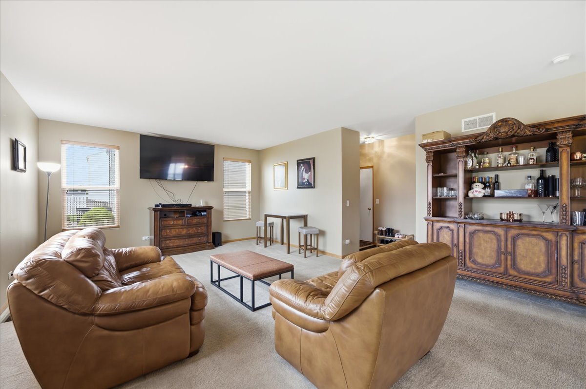 1916 Castle Ridge Drive Plainfield, IL 60586 - Photo 9 of 36 a living room with furniture a rug and a fireplace