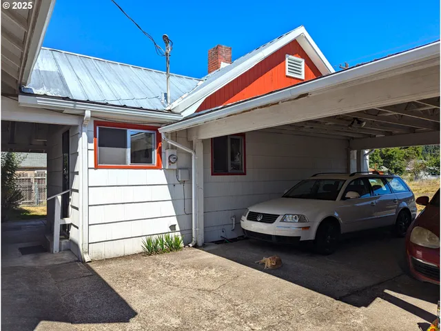 a front view of a house with parking space