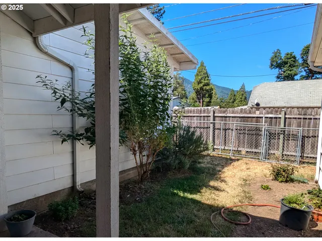 a view of a house with a backyard and garden