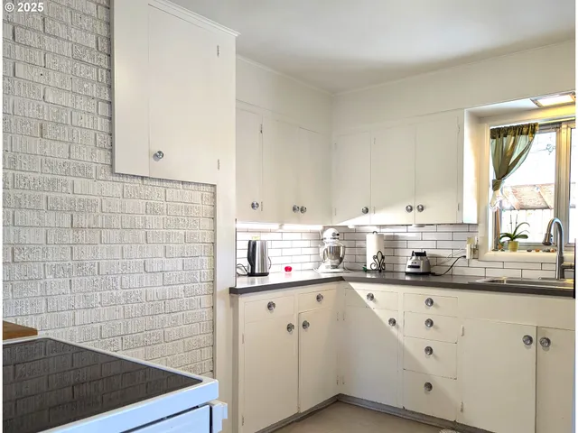 a utility room with multiple dryer and washer