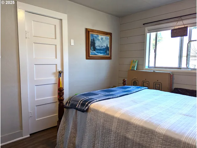 a bedroom with a bed and a window