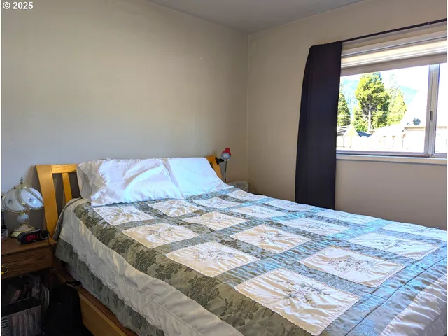 a bedroom with a bed and a window