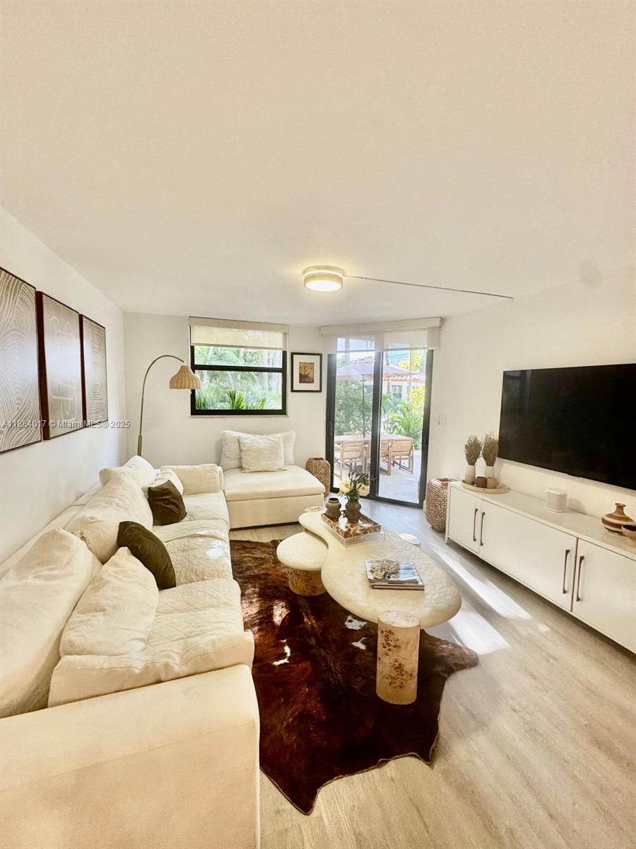 55 Ocean Ln Drive, Unit 1018 Key Biscayne, FL 33149 - Photo 11 of 36 a living room with furniture and a flat screen tv