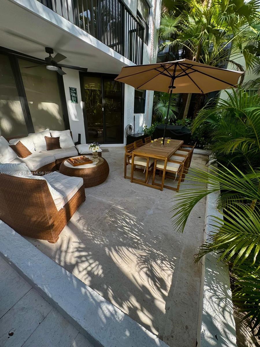 55 Ocean Ln Drive, Unit 1018 Key Biscayne, FL 33149 - Photo 24 of 36 an outdoor space with patio and white umbrellas