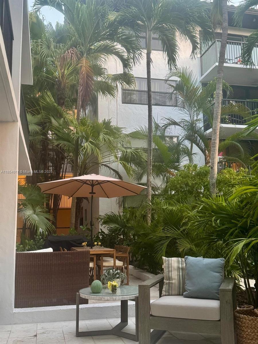 55 Ocean Ln Drive, Unit 1018 Key Biscayne, FL 33149 - Photo 31 of 36 a view of a patio with couches table and chairs and potted plants