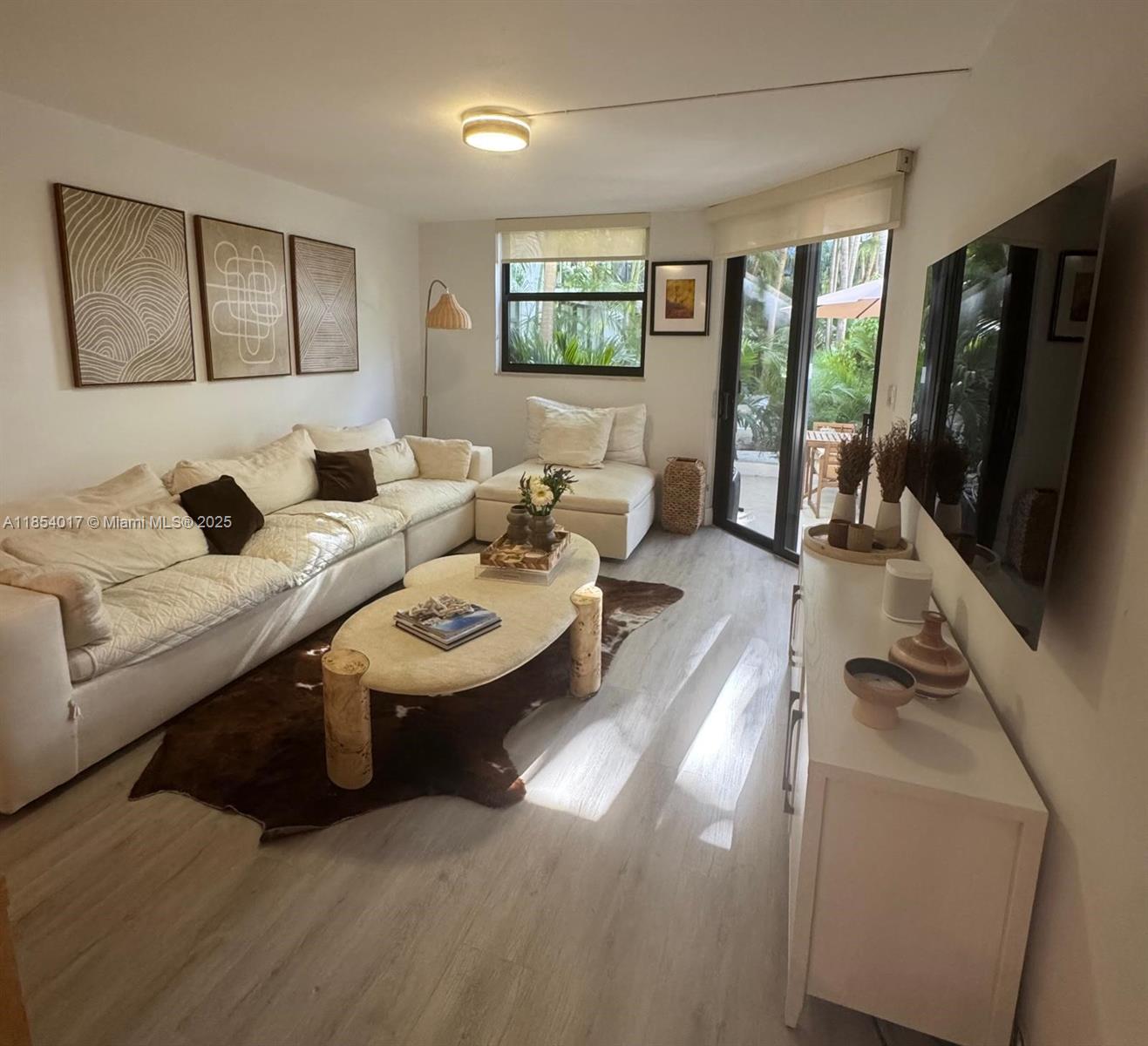 55 Ocean Ln Drive, Unit 1018 Key Biscayne, FL 33149 - Photo 10 of 36 a living room with furniture and a flat screen tv