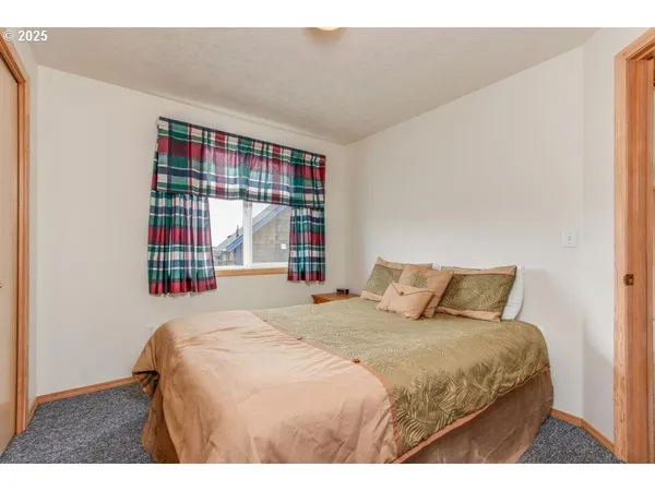 a bedroom with a large bed and a window