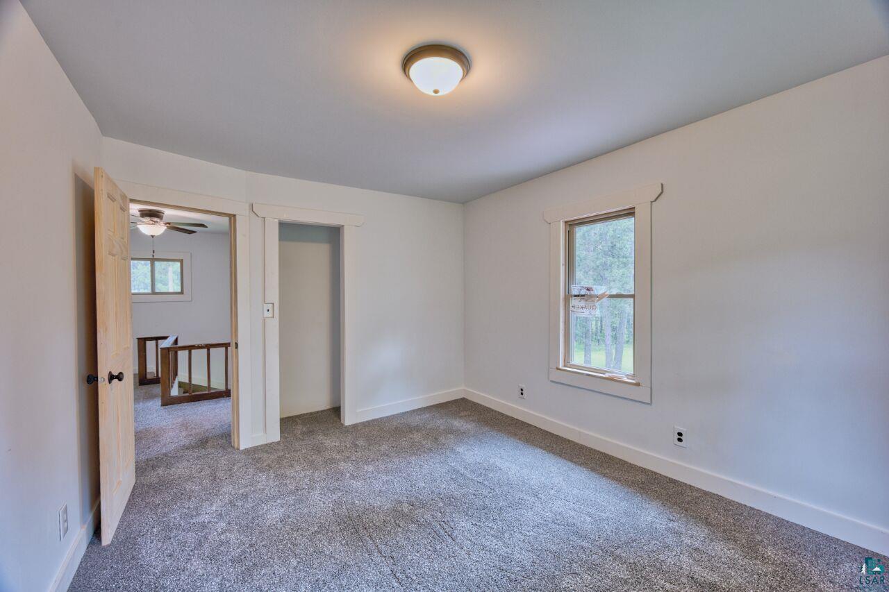 4755 Judd Road Gilbert, MN 55741 - Photo 22 of 50 Unfurnished bedroom with carpet flooring and baseboards