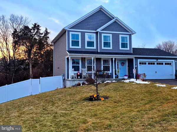 a view of a house with swimming pool and sitting area