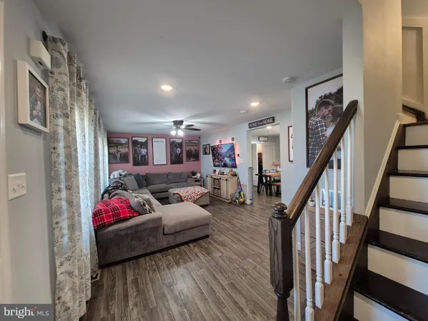 a living room with furniture or stairs and a wooden floor