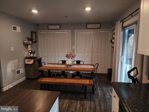 a view of a room with furniture and wooden floor