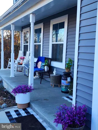 a view of a dining room with chairs and potted plants