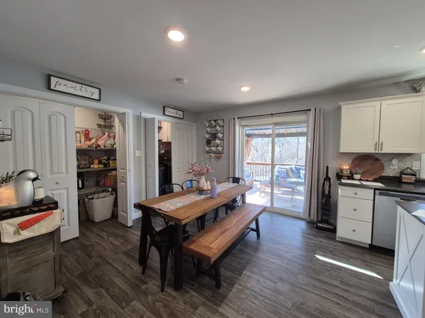a large kitchen with a table and chairs in it