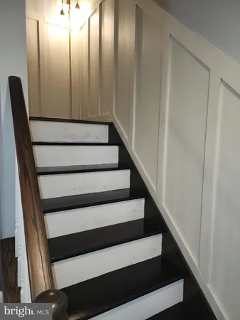 a view of staircase with rug