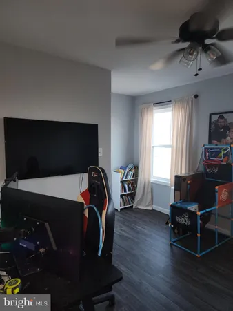 a view of a closet area with hardwood floor
