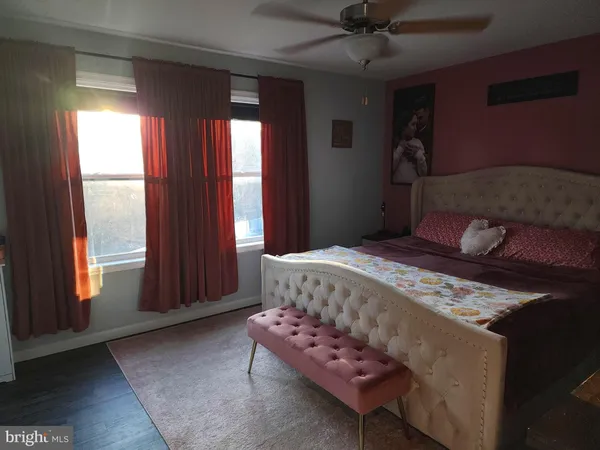 a view of a hallway with closet and wooden floor