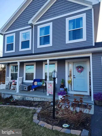 a front view of a house with sitting area