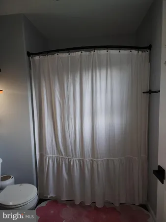a view of a hallway with wooden floor and door